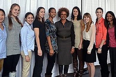 Paula Madison (center) poses with the MIT women's basketball team.