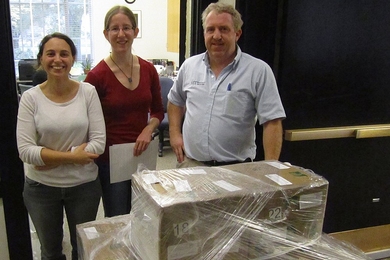 From left, Derya Akkaynak Yellin, PhD student in the Department of Mechanical Engineering and WHOI; her friend Krista Ehinger, PhD student in the Department of Brain and Cognitive Sciences; and Michael Fahie of the Department of Facilities pack and load the books onto pallets for shipping.