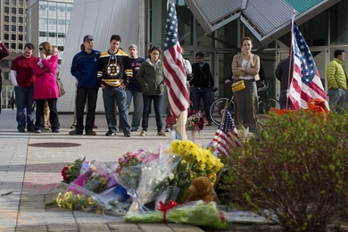 Community members and other visitors gather on Saturday at a makeshift memorial for MIT Police Patrol Officer Sean Collier, who was killed in the line of duty on the evening of Thursday, April 18.