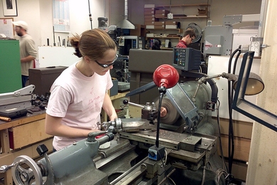 Graduate student Arolyn Conwill turns a piece of copper.