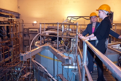 U.S. Senator Mary Landrieu of Louisiana (back), atop Alcator C-Mod, learns from Assistant Professor Anne White how MIT's tokamak has contributed to the national and international fusion programs.
