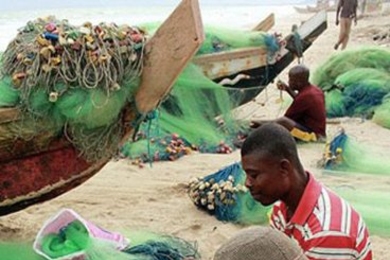 Fishermen weave nets on a seashore in Ghana. This was the winning entry in the 2013 J-PAL and Innovations for Poverty Action staff photo contest.