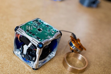 A prototype of a new modular robot, with its innards exposed and its
flywheel &#8212; which gives it the ability to move independently &#8212; pulled out.