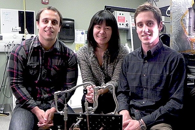 Associate Professor of Mechanical Engineering Evelyn Wang (center), post-doctoral associate Nenad Miljkovic (left) and graduate student Andrej Lenert (right) pose with the solar thermal photovoltaic experimental system.