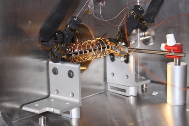 An open structure of copper wire surrounding a pipe was used in the
lab to measure how effective an electric field can be in pulling
droplets away from a condenser surface. In combination with a particular
kind of superhydrophobic surface, the new system can nearly double the
efficiency of the cooling process, the researchers found.