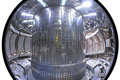 Interior view of the tokamak showing the molybdenum armor tiles on the wall. Three Ion Cyclotron Range of Frequencies (ICRF) heating antennas are visible – two on the left with two copper straps each, and the four-strap “field-aligned” antenna (installed 2011) at right.