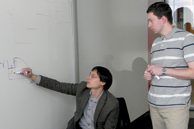Collaborators, Jeff Gore (left) of MIT and Kirill Korolev of Boston University discuss joint research into range expansions. They suggest applying ecological and evolutionary lessons from dynamics of microbial populations to treating human cancers in a paper co-authored with Joao B. Xavier of the Memorial Sloan-Kettering Cancer Center. 