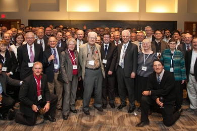 Large group of people stand posing for photo