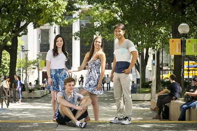 Four students outside MIT main entrance