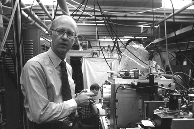 Professor James L. Kinsey, circa 1978, with graduate student Edmond Murphy in the background.