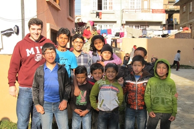 Gabriel Ravel '17 poses with Bloom Nepal students in December 2014.