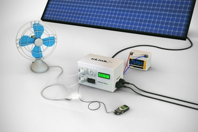 The key element of the new microgrid system is the power management unit, seen at the center in this rendering. Various devices — shown here as a fan, a light, and a cellphone charger — can be plugged directly into the unit, along with lines to supply power to other houses. The unit manages the power coming in from solar panels (shown at top), and sends the power either to the devices or, if n...