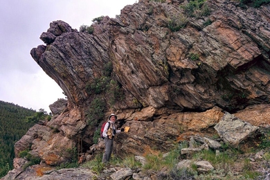 A rock outcrop in Gordon Gulch, Colo., with Stephen Martel of the University of Hawaii pictured in the foreground.