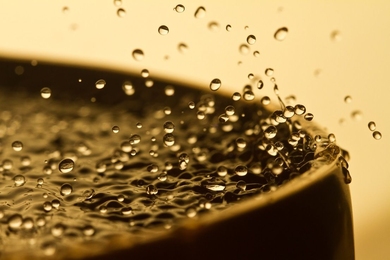 Water drops ejected from the surface of a Tibetan singing bowl.