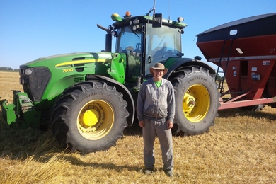 Matt Reimer stands in front of his driverless tractor in Manitoba, Canada.