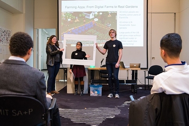 Priyanka Chatterjee ’15, a grad student in the Institute for Data, Systems, and Society, acts out the welcome video for a gardening app that could help homeowners reduce carbon emissions. Chatterjee and her teammates Casey Stelmach, a grad student at the MIT Sloan School of Management, and James Minor, a grad student in the Department of Electrical Engineering and Computer Science, won the “be...