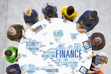 14 people sit at round table with text on it.