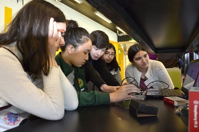 A volunteer from Lincoln Laboratory helps students program Instagram-style filters.