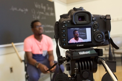 Nicholas Okafor, head online facilitator for the MIT Online Science, Technology, and Engineering Community (MOSTEC) program, records a video in advance of students' arrival at MIT this month.