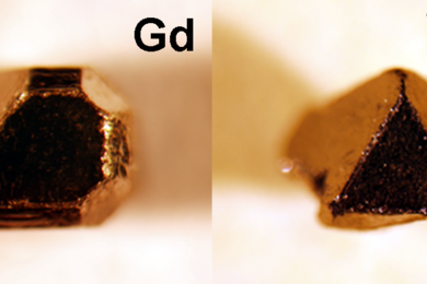 At left: A single crystal compound of gadolinium, platinum, and bismuth made with naturally occurring elements. At right, a single crystal of this material made with isotopically enriched gadolinium for neutron scattering experiments. Both crystals are approximately 1 mm in size.