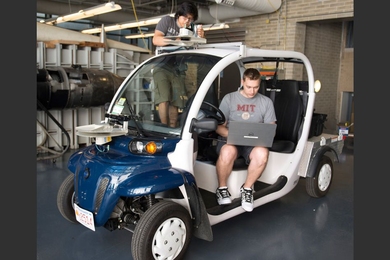 MIT junior Wally Wibowo (left) and graduate student Justin Miller prepare an electric vehicle for the Aerospace Controls Lab mobility-on-demand research.