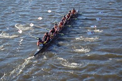 To the cheers of teammates and family on the Weeks Footbridge, the Varsity 8 row by in synch, steadily gaining on Princeton University at the Head of the Charles Regatta. Along with a four-rower boat in lightweight women’s crew, the MIT rowers are about to make program history. Left to right: Chloe Thacker (coxswain), Priya Veeraraghavan (captain), Sharon Wu (captain), Elizabeth Martin, Annika R...