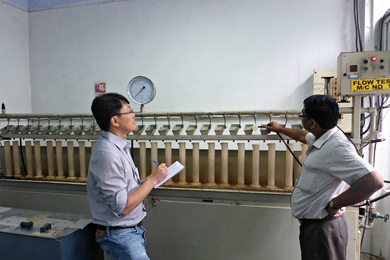 Ruo-Qian Wang (left) worked with engineers at Jain Irrigation Systems in Jalgaon, India, to understand the design requirements for high-efficiency irrigation technology.