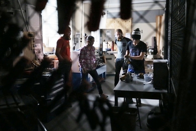 Maker mentor Alisha Schor, second from left, teaches students on the use of equipment in the MIT MakerWorkshop.
