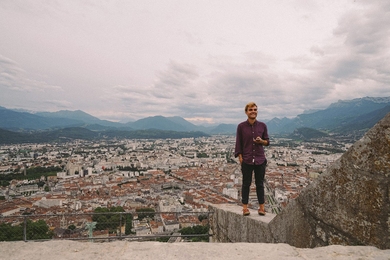 MISTI participant Andrei Ivanov '16 is pictured with the city of Grenoble, France, in the background.