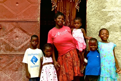 In Haiti, Makilene Velnis stands with her family in front of the home she bought with money she earned working at the Apparent Project, a nonprofit artisans’ guild. The documentary "Poverty, Inc.," co-produced by MIT grad student Mark Weber, explores how the foreign aid and charity industry may be doing more harm than good.