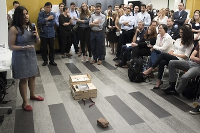 At a "pitch and demo" DesignX accelerator event, Department of Urban Studies and Planning student Riddhi Shah, lead for the Kumej project, makes her pitch to the crowd. Kumej is a light, collapsible seat designed to enable underprivileged students in India to carry and create their own comfortable work surface, whether at a construction site where their parents work or in a rural school.