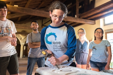Brenda Stern ’17 carves marble with a mallet and chisel, traditional Italian tools, during the MIT Materials in Art, Archaeology and Architecture program in Italy.