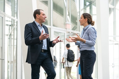 David Autor (left), a professor economics, and Asu Ozdaglar, a professor of electrical engineering, discuss 6-14: Computer Science, Economics, and Data Science. The new major is designed to train students to become the unseen game-makers behind virtual markets. 