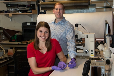 Research by MIT graduate student Ashley Kaiser (left) and postdoc Itai Stein shows that a small fraction of carbon nanotubes added to phenol-formaldehyde resin lowers the processing temperature needed to achieve the best combination of hardness and low density by 200 degrees Celsius.