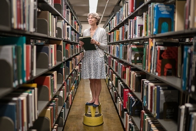 MIT librarian Chris Sherratt works the stacks. She specializes in helping students find information on atmospheric and oceanic sciences, energy and environment, and nuclear science and engineering.