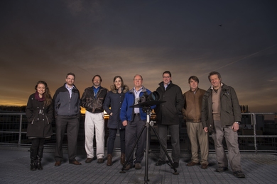 Lincoln Laboratory researchers pose with the LASSOS sensors: (l-r) Emily Clemons, Tom Reynolds, and Brad Crowe of the Air Traffic Control Systems Group; Erin Tomlinson, Rich Westhoff, Brian Saar, Michael Joffe, and John Flint of the Laser Technology and Applications Group.