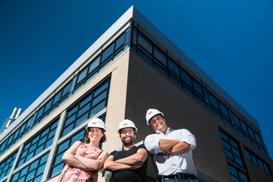 Associate professors Julie Shah, Sertac Karaman, and Amos Winter, in front of the newly renovated Building 31.