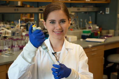 2017 MPC-CMSE Summer Scholar Gaetana Michelet holds a pipette in the Biogel Lab of Katharina Ribbeck, the Eugene Bell Career Development Professor of Tissue Engineering at MIT. Ribbeck studies how complex materials such as mucus influence bacterial behavior.
