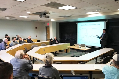 Guest speaker Peter Krause presents a chart measuring changes over time in the rate of political violence in Algeria.