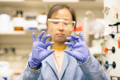 MIT postdoc, Grace Han, handles a new chemical composite that could provide an alternative to fuel by functioning as a kind of thermal battery. 
