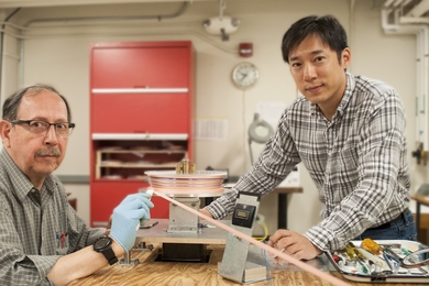 Research Engineer Dongkeun Park (right) and his colleague Juan Bascuñán wind a double-pancake coil with high-temperature superconductor.