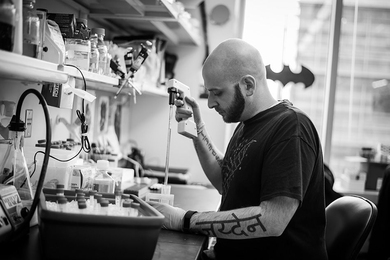 Ryan Kohn, a PhD candidate in the MIT Biology Department’s Jacks Lab, holds a photo of his son, Jayden.
