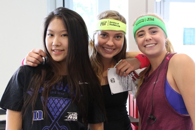 Students attending the 2017 Wellness Fair show off their swag from different campus organizations.