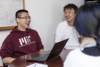 Graduate student Tianli Zhou (left) during a lab meeting. Zhou is studying how to make transportation systems more efficient, particularly through vehicle-sharing services.