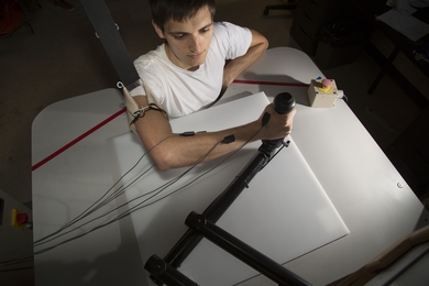 Graduate student James Hermus demonstrates a production robot based on the original MIT-MANUS design in the Eric P. and Evelyn E. Newman Laboratory for Biomechanics and Human Rehabilitation. The robot, which helps stroke victims recover and regain mobility, represents one of the many ways MIT's mechanical engineering researchers are working to improve health care. 