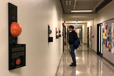 A plaque describing the sun (far left) begins the Infinite Solar System installation on the third floor of the Infinite Corridor near Lobby 7.