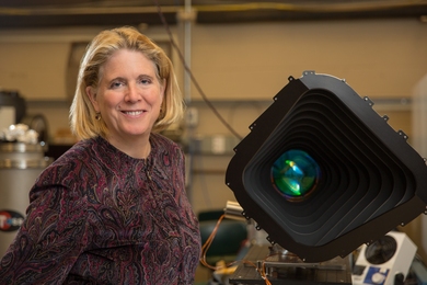 MIT Kavli Institute director Jacqueline Hewitt stands with a prototype of one of the four cameras aboard the Transiting Exoplanet Satellite Survey (TESS) instrument. Hewitt, who has overseen the TESS mission from NASA proposal to satellite launch in April, will step down as Kavli Institute director in January.