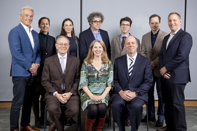 The 2018 Bose Research Fellows (standing) pose for a photo with (seated, l-r) President L. Rafael Reif, Judy Bose, and Provost Martin Schmidt.