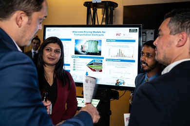 MIT graduate students Atmaja Sinha and Rakesh Thykandi speak with executives from trucking companies about their work to reduce transportation costs for consumer good companies during the MIT Global Supply Chain and Logistics Excellence (SCALE) Network Research Expo 2019. 