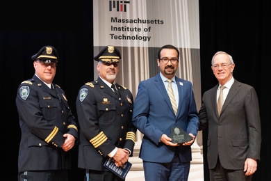 2019 Collier Medal recipient Arman Rezaee (second from right), MIT PhD candidate in the Department of Electrical Engineering and Computer Science, receives his award from Captain Craig Martin (left), MIT Police Chief John DiFava (second from left), and President L. Rafael Reif.